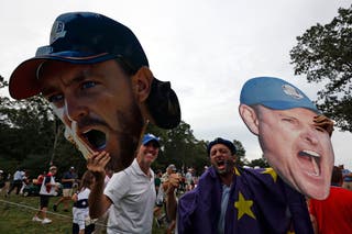 Fans of Team Europe react while at the 16th hole